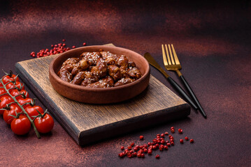 Chicken hearts fried in soy sauce with salt and spices in a plate