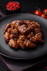 Chicken hearts fried in soy sauce with salt and spices in a plate