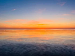 Fototapeten Orange sky after the sunset at the sea, evening sea horizon  © Oksana