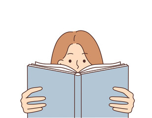 Inquisitive woman reads book wanting to gain new knowledge from educational literature