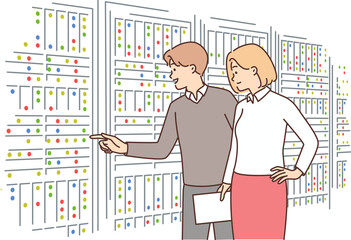 Man and woman inspect server equipment choosing place to store and process big data