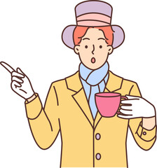 Mysterious man dressed as hatter from story Alice in Wonderland drinks tea and points finger to side