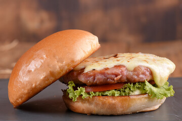 hamburger sandwich with melted cheese lettuce tomato mayonnaise and bread delicious fast food traditional snack