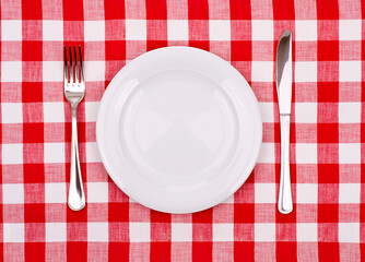 Plate knife and fork on a checkered tablecloth