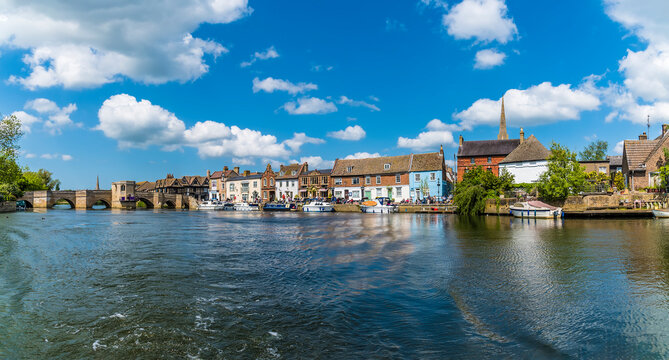 A view of a settlement on the shore of the River Great Ouse near to St Ives, Cambridgeshire in summertime