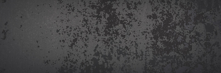 Dark wide panoramic background. Peeling paint on a concrete wall. Faded dark texture of old cracked flaking paint. Weathered rough painted surface with patterns of cracks. Shaded background for design
