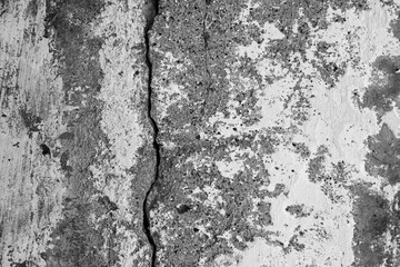 Texture of an old cracked concrete wall. Rough gray concrete surface. The gap between the...