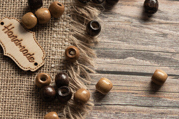 burlap wooden beads of light and dark shade on a wooden background,makrophoto