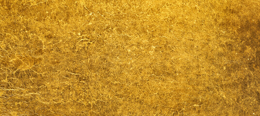 Rough metallic golden surface texture. Shiny gold crinkled background.