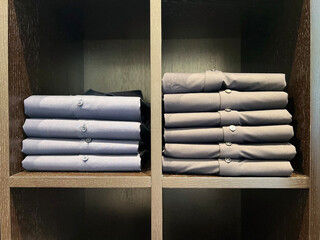 shirts are stacked on the shelf. Style and wardrobe. Shopping.