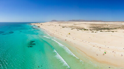 Beautiful mid level aspect aerial panoramic view of Grandes Playa beach with clear turquoise water near Corralejo in Fuerteventura Spain