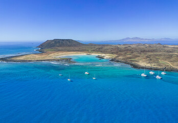 Aerial panoramic view of the beautiful secluded natural bay of the island of Lobos near Corralejo...