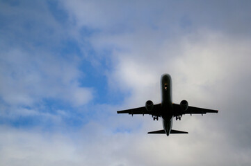 The plane against the background of cloudy skies, the plane took off from the runway.