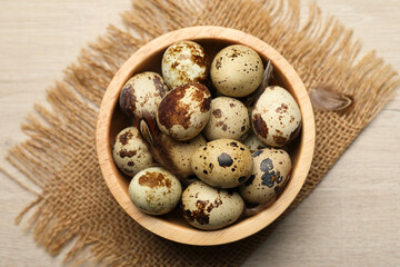 Obraz na płótnie Canvas Speckled quail eggs on white table, top view