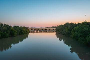 Fototapeta premium San Rafael Bridge at Guadalquivir River at sunset - Cordoba, Andalusia, Spain
