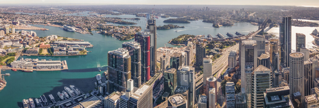 Panoramic aerial drone view of Sydney City and Sydney Harbour overlooking Barangaroo waterfront precinct in Sydney, NSW Australia on a sunny day