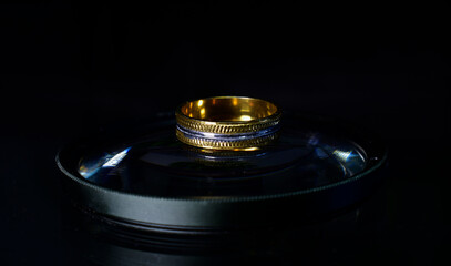 The wedding ring is a gold ring decorated with diamonds.