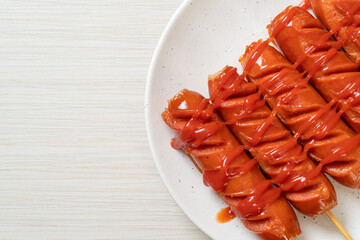 fried sausage skewer with ketchup
