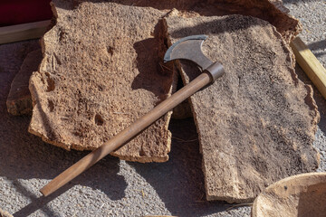 antique axe to cut the bark of the cork oak to extract the cork.