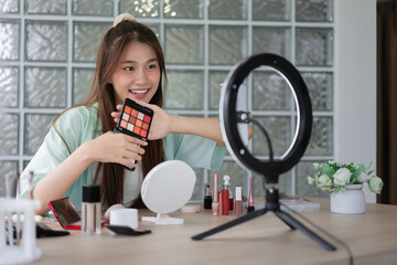 Beauty influencer concept, Young woman show eyeshadow to present product and record video for Vlog