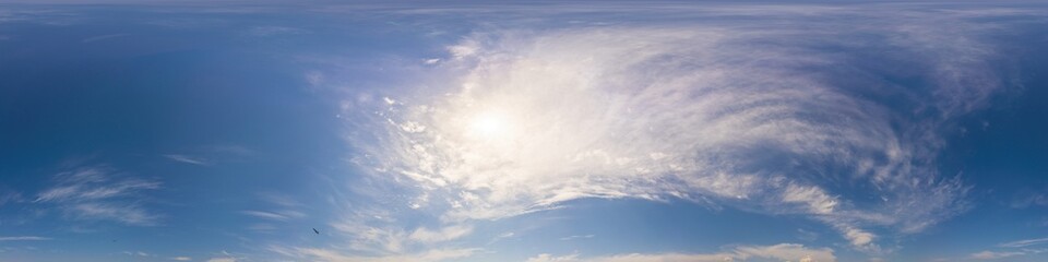 Obraz premium Blue summer 360 panorama of sky with clouds, no ground, in spherical equirectangular format for easy use in 3D graphics and aerial or ground composites, seamless and suitable for sky replacement.