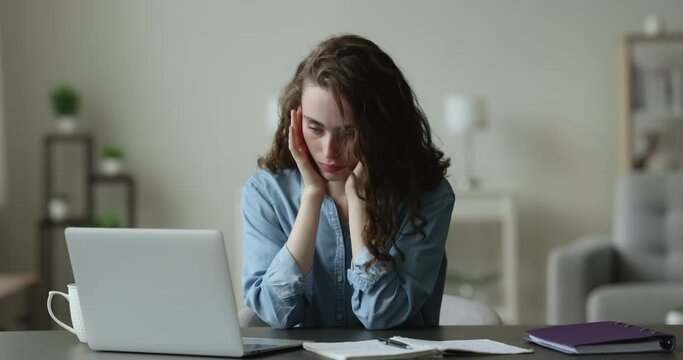 Tired overworked freelance employee girl sitting at work laptop, dropping head, on table, falling asleep. Young woman, exhausted student suffering from lack of sleep, feeling fatigue