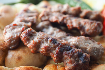 Kebab, traditional turkish meat food with salad on a plate 