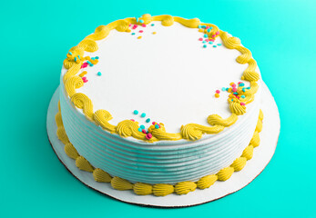 Circular White Ice Cream Cake with Colorful Border and Sprinkles on a Blue Background