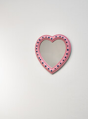 Pink Heart with blue dots mirror frame isolated on white background