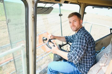 Farmer driving combine and harvesting crop.