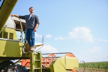 Farmer controls the combine harvester.