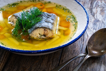 Fish soup on wooden table
