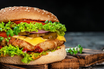 Tasty grilled home made burgers with beef, tomato, cheese, and lettuce. fast food and junk food concept