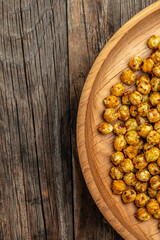 fried chickpeas on a dark background. Traditional Indian cuisine. Tasty vegetarian and vegan chickpea snack. banner, menu, recipe place for text, top view