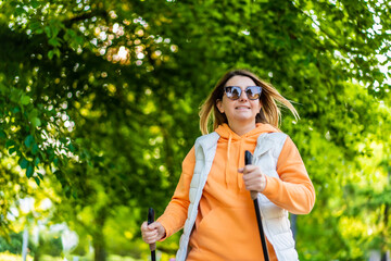 Nordic walking - woman training in city park
