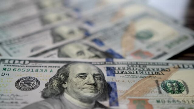 Hundred dollar bill close up in camera slow motion. Dollars American banknotes value of 100. Close-Up of banknotes. Dollars money. Cash of hundred dollar bills.