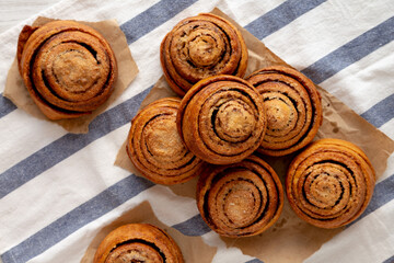 Homemade Cinnamon Roll Pastry on a white wooden background, top view. Flat lay, overhead, from above.