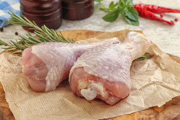 Raw chicken leg over board