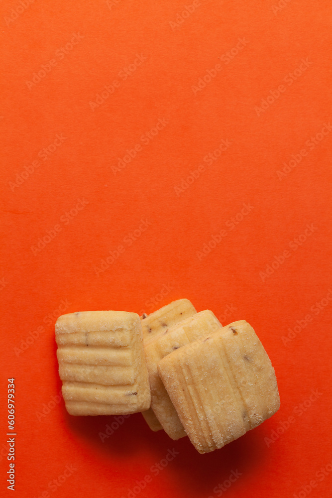 Wall mural Stacked Cumin Cookies or Indian Jeera Cookies.On orange background. Top-down view. Food Flat lay.