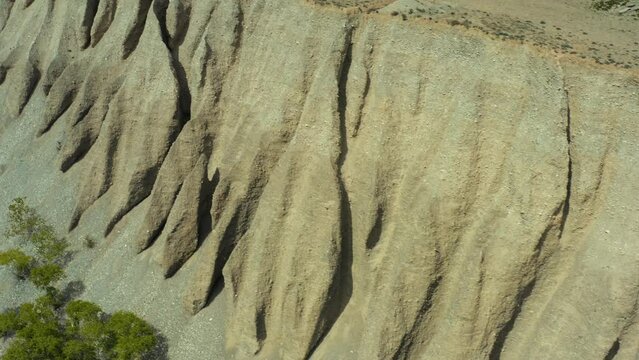 Beautiful landscape on sandy mountains. Aerial drone view sandy desert canyon with steep slopes, Kyrgyzstan, Central Asia.
