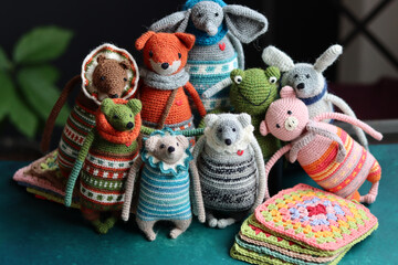 Crochet stuffed animals close up photo. Hand made Amigurumi toys on dark background with copy space. Cute crochet gift. 