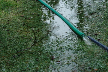 The water hose came off the plastic pipe. flood the lawn