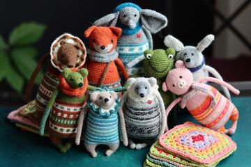 Crochet stuffed animals close up photo. Hand made Amigurumi toys on dark background with copy...