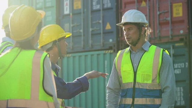 diversity worker foreman and secretary using document file meeting with worker to checking  control loading Containers box at warehouse logistic in Cargo freight ship for import export in harbor.