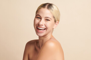 Beautiful smile of young woman with healthy white teeth on beige background, Dental care. Dentistry...