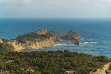 Fototapeta na wymiar Sea landscape with cliffs, on a clouday day, in Jávea (Alicante, Spain)