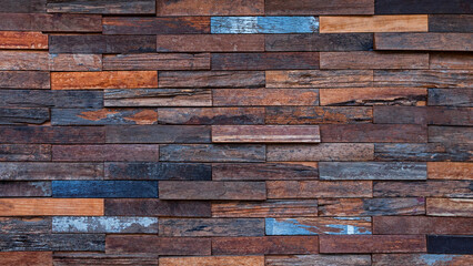 Exposed wooden wall exterior, Patchwork of raw wood forming a beautiful parquet wood pattern....
