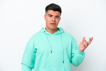 Naklejka premium Young caucasian handsome man isolated on white background making doubts gesture