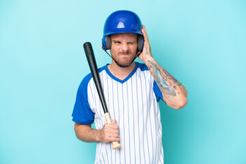 Baseball player with helmet and bat isolated on blue background frustrated and covering ears