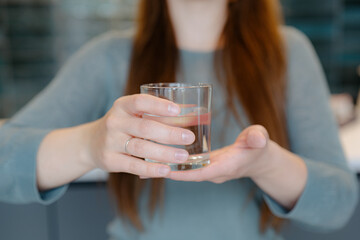 Close up image of woman holding in her hands clear glass of water 